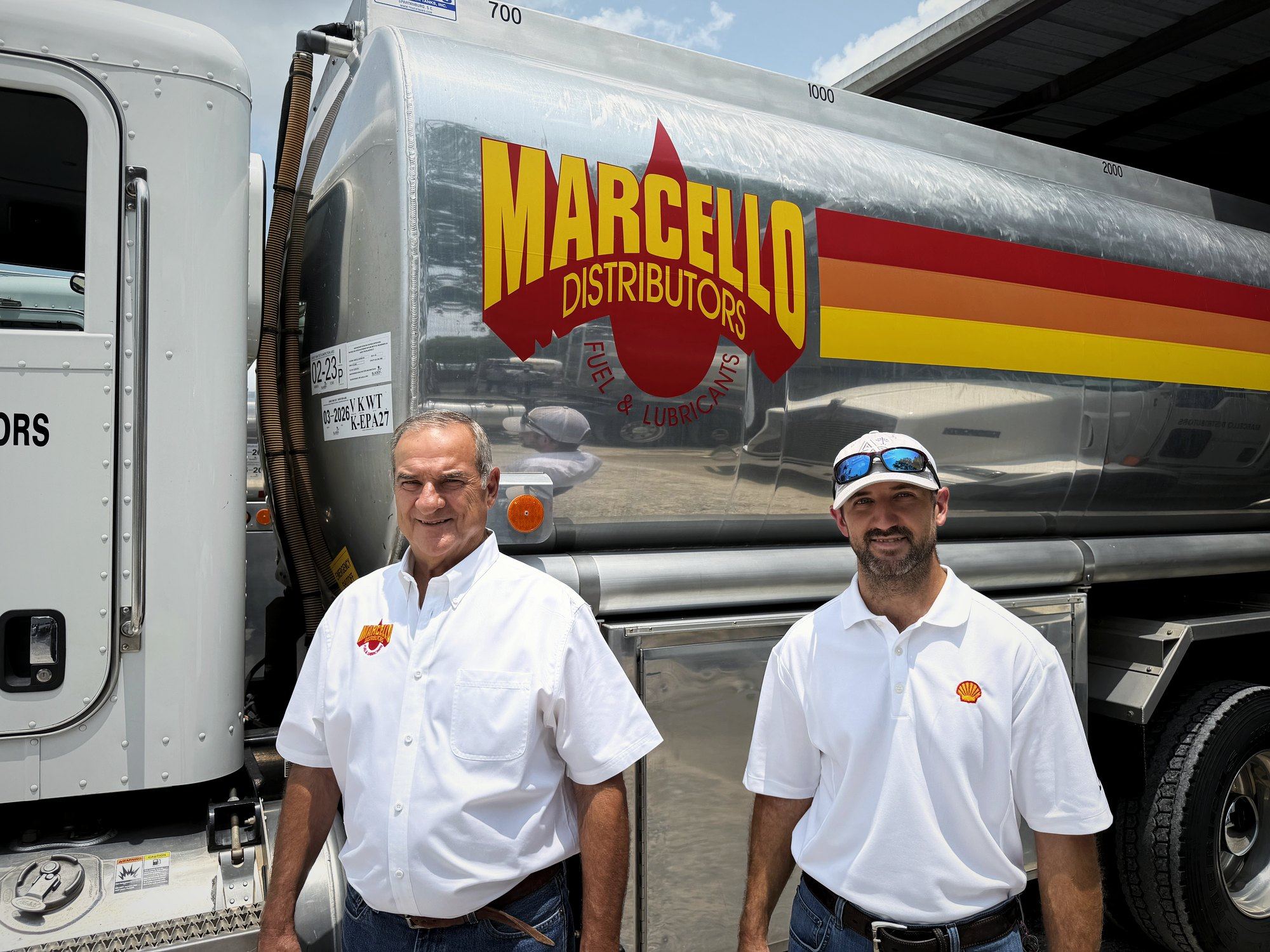 Marcello Distributors leadership standing beside a company tanker at the Donaldsonville yard